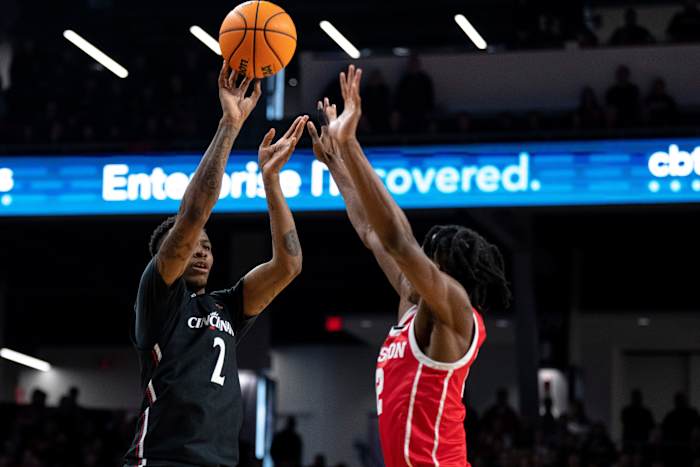 Cincinnati Bearcats guard Landers Nolley II (2) hits a 3-point shot over Houston Cougars guard Tramon Mark (12) in the first half of the NCAA men s basketball game between the Cincinnati Bearcats and the Houston Cougars at Fifth Third Arena in Cincinnati on Sunday, Jan 8, 2023. Ncaa Basketball Houston Cougars At Cincinnati Bearcats